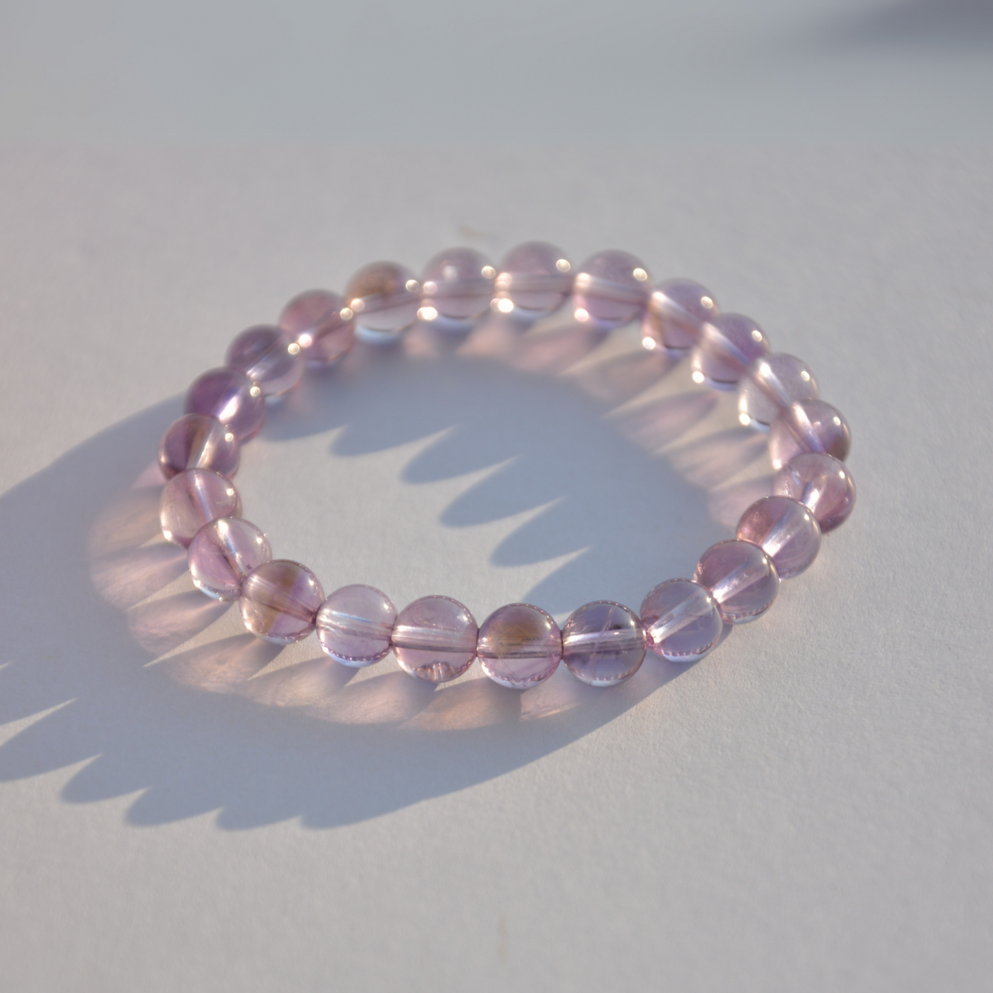 Detailed view of a 6mm Brazilian Amethyst bead strand, showcasing the vibrant purple crystals and fine craftsmanship